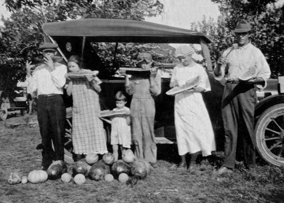 The family eating watermelon.